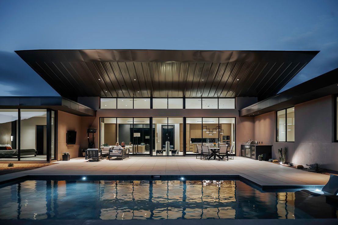 Modern desert home with expansive glass walls and cantilevered roof in Carefree, Arizona, designed by Spry Architecture